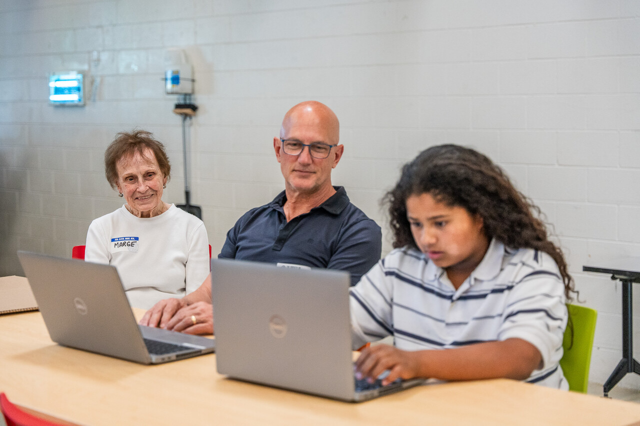 Margaret and one of her children help a student guest in the Dream Center.