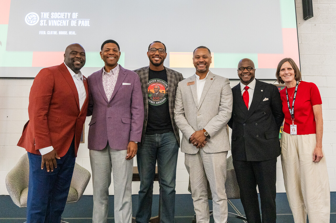 The speakers from the event post for a group photo.
