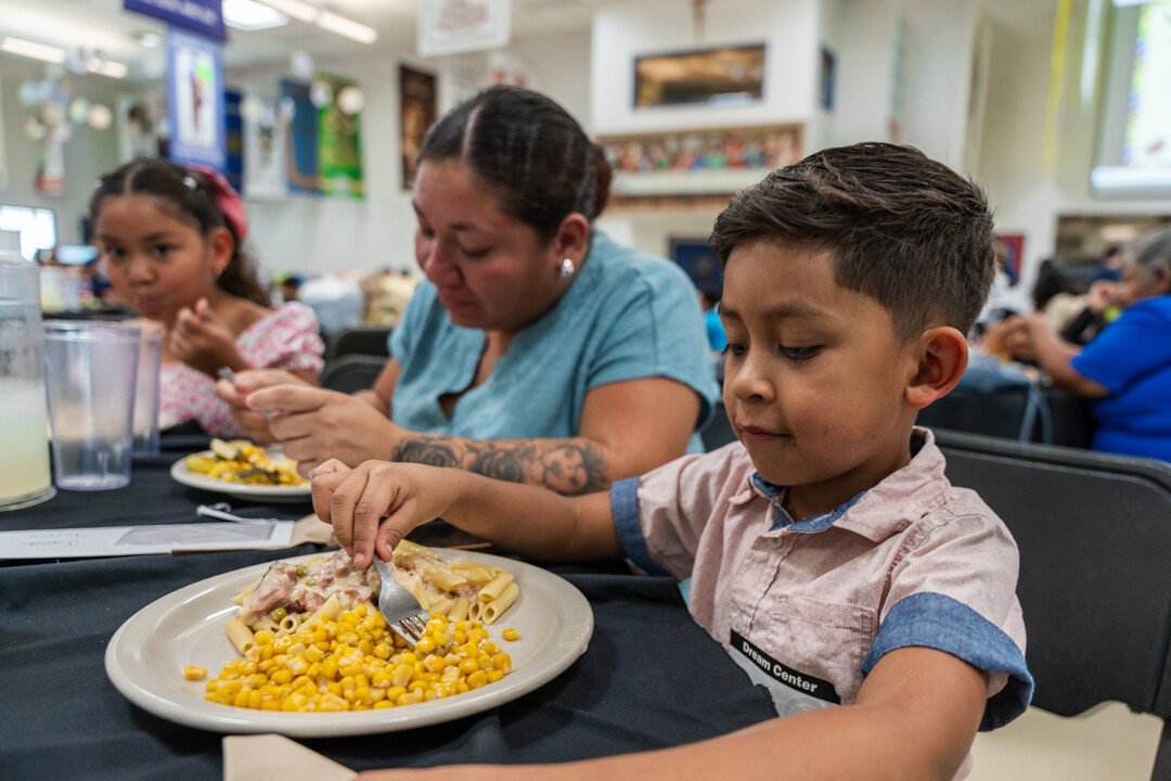 Estrella's youngest, Jacob, enjoys the meal at FEM.